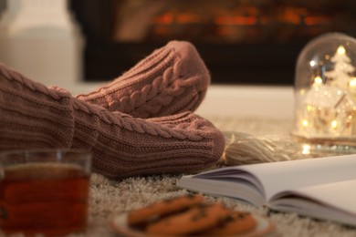 Woman in knitted socks resting at home, closeup