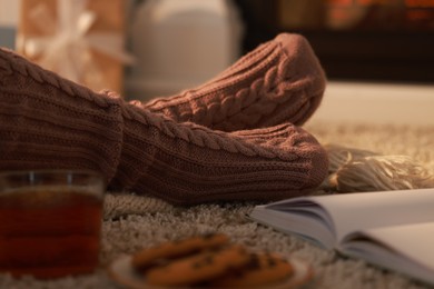 Woman in knitted socks resting at home, closeup