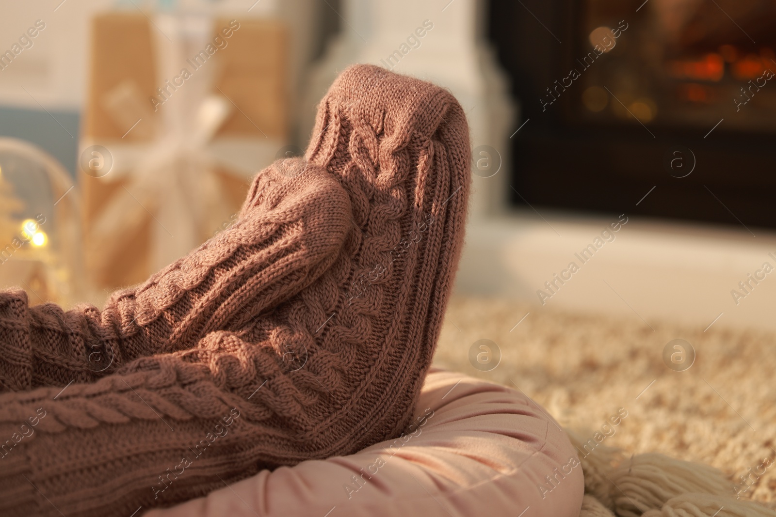 Photo of Woman in knitted socks resting at home, closeup. Space for text