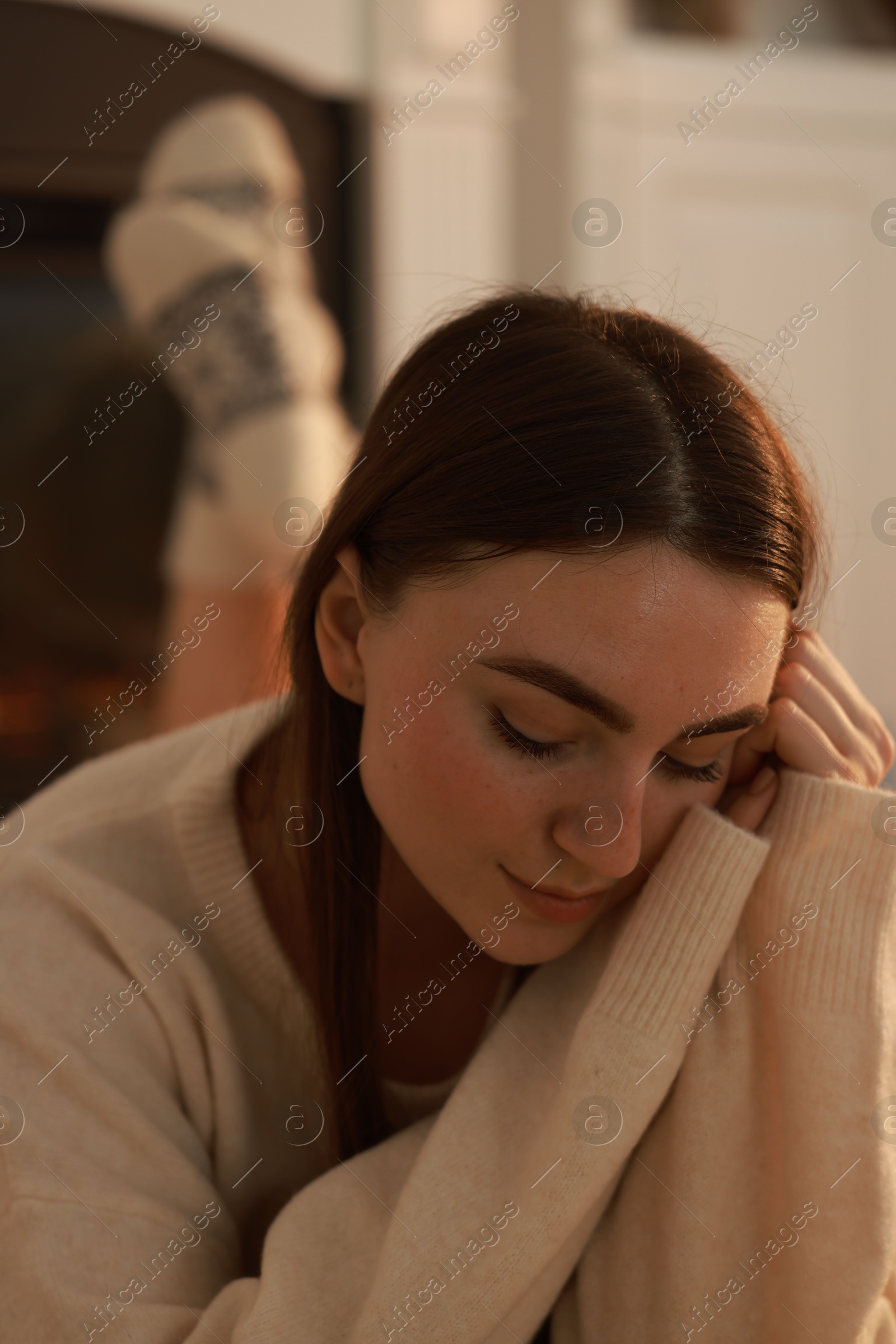 Photo of Woman in warm sweater resting at home