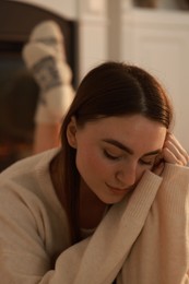 Photo of Woman in warm sweater resting at home