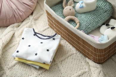 Photo of Baby clothes on sofa at home, closeup