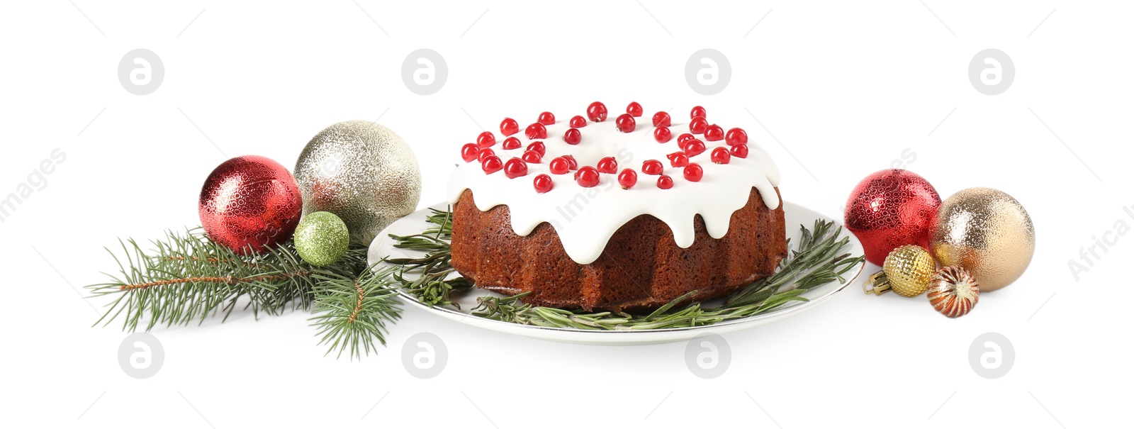 Photo of Tasty Christmas cake with red currants, rosemary, fir branches and baubles isolated on white