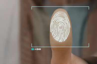 Image of Woman pressing finger to surface showing friction ridges pattern, closeup. Scanning fingerprint