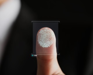 Image of Man pressing finger to surface showing friction ridges pattern, closeup. Scanning fingerprint