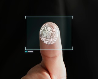 Image of Man pressing finger to surface showing friction ridges pattern, closeup. Scanning fingerprint