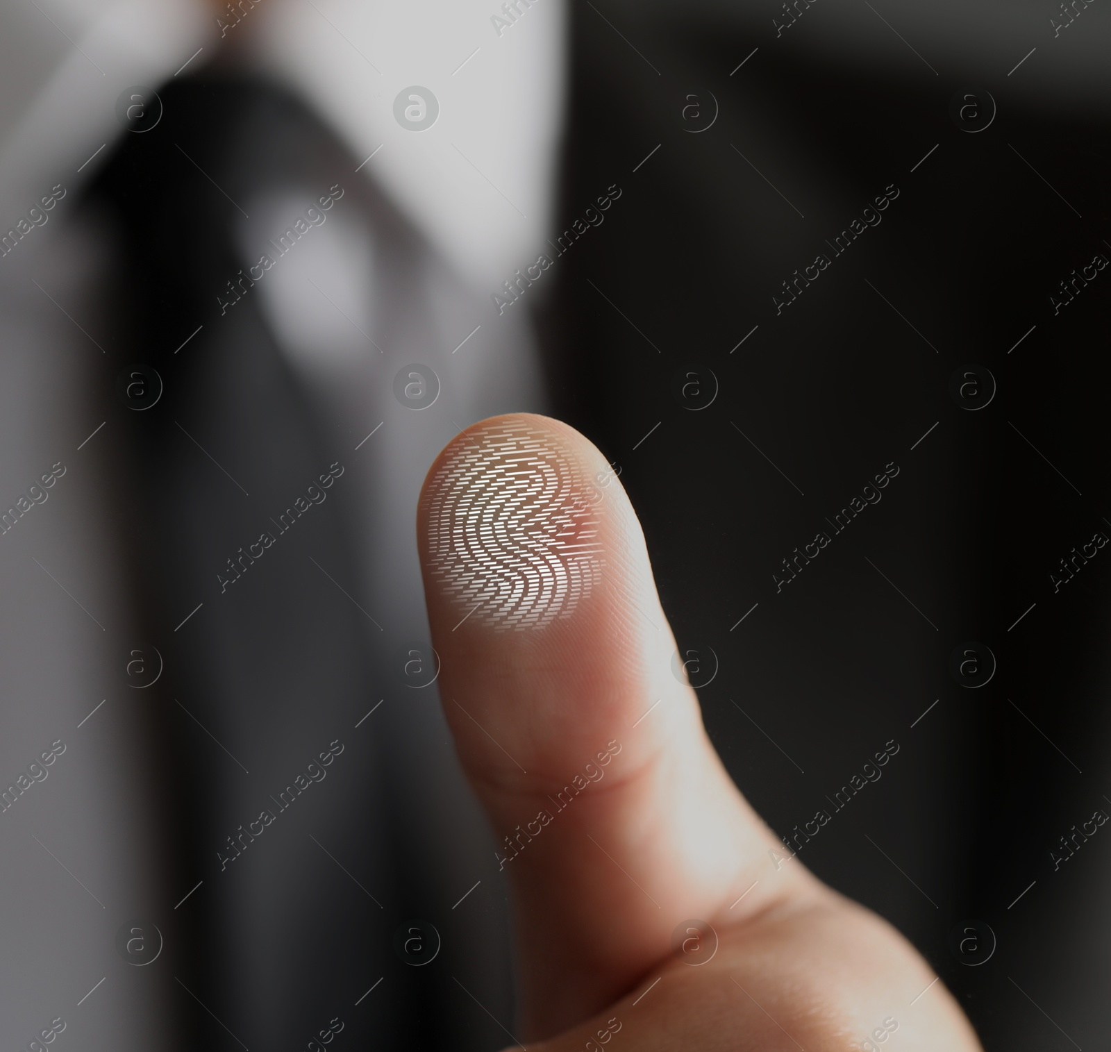 Image of Man pressing finger to surface showing friction ridges pattern, closeup. Scanning fingerprint