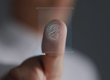 Image of Man pressing finger to surface showing friction ridges pattern, closeup. Scanning fingerprint