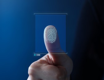 Image of Woman pressing finger to surface showing friction ridges pattern, closeup. Scanning fingerprint