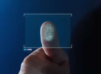 Image of Woman pressing finger to surface showing friction ridges pattern, closeup. Scanning fingerprint