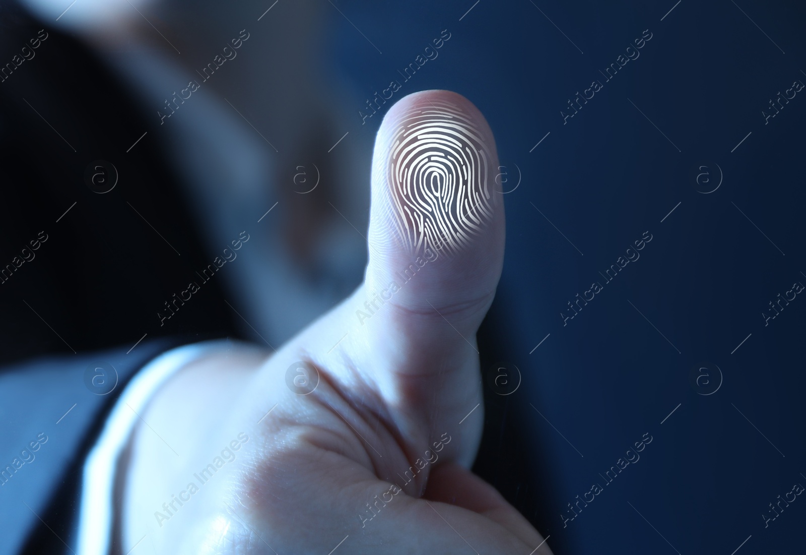 Image of Woman pressing finger to surface showing friction ridges pattern, closeup. Scanning fingerprint