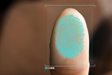 Image of Woman pressing finger to surface showing friction ridges pattern, closeup. Scanning fingerprint