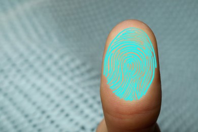 Image of Woman pressing finger to surface showing friction ridges pattern, closeup. Scanning fingerprint