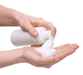 Photo of Woman applying cleansing foam onto hand on white background, closeup