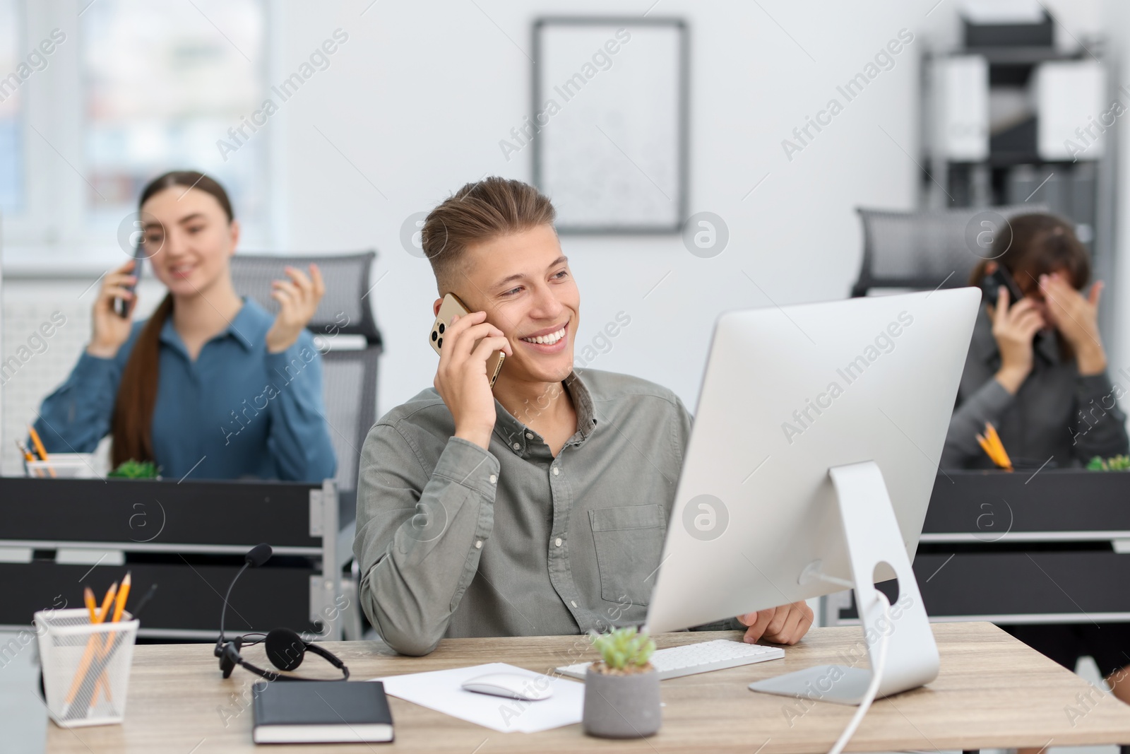 Photo of Sales department. People calling to clients in office, selective focus