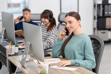 Photo of Sales department. People calling to clients in office, selective focus