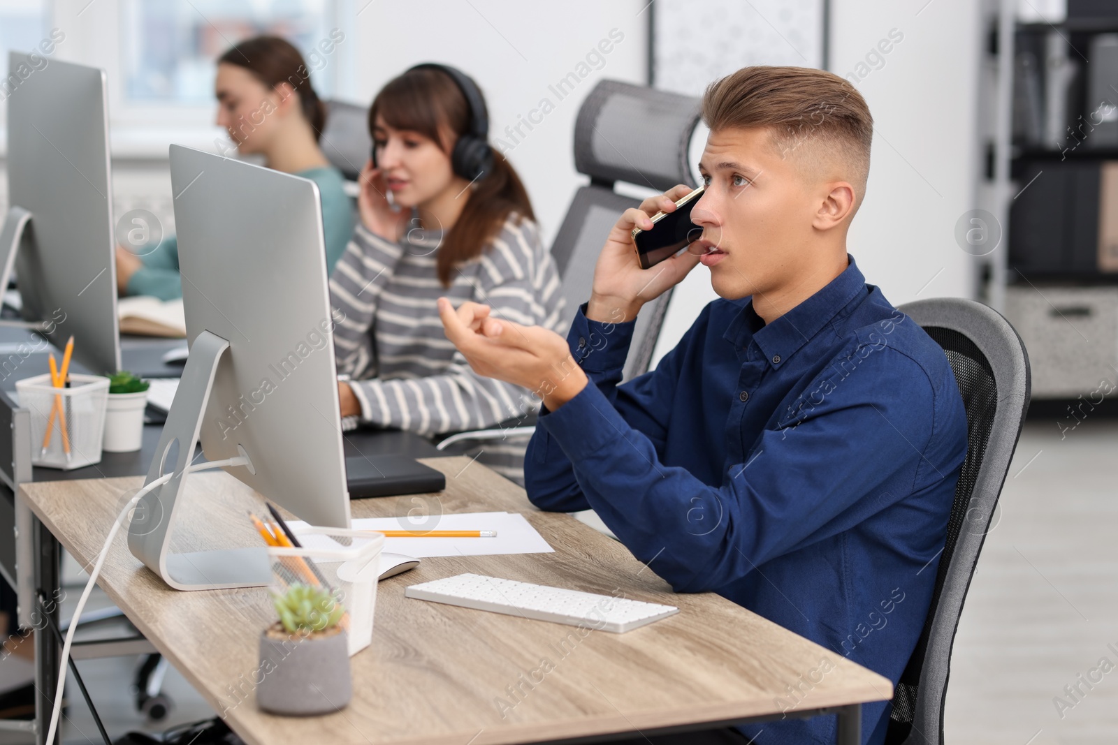 Photo of Sales department. People calling to clients in office, selective focus