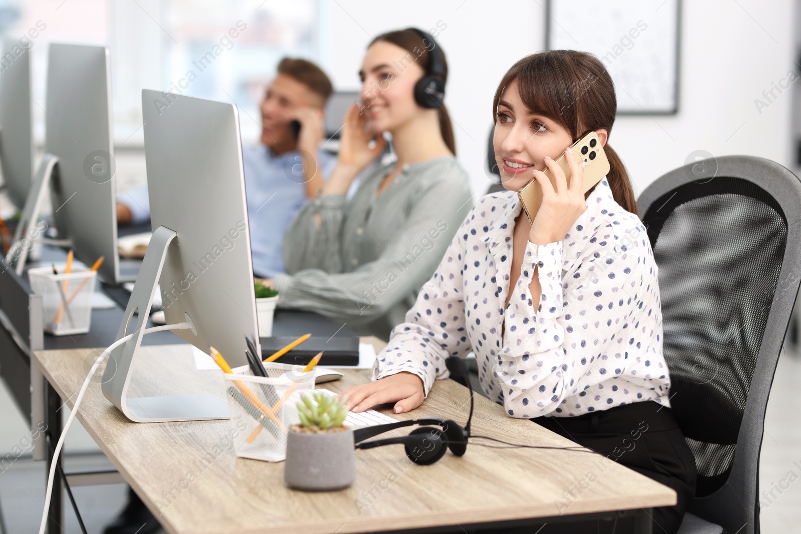 Photo of Sales department. People calling to clients in office, selective focus