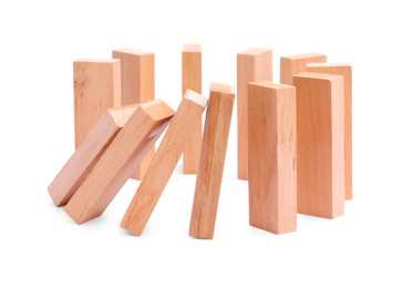 Photo of Domino effect. Wooden blocks falling on white background