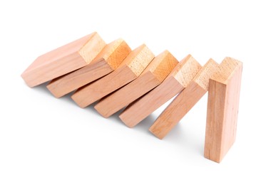 Photo of Domino effect. Wooden blocks falling on white background