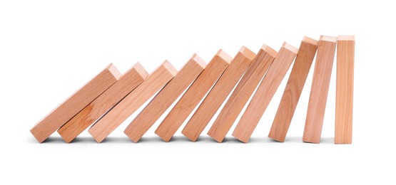 Photo of Domino effect. Wooden blocks falling on white background