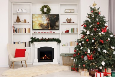 Photo of Beautifully decorated Christmas tree near fireplace in room. Festive interior design