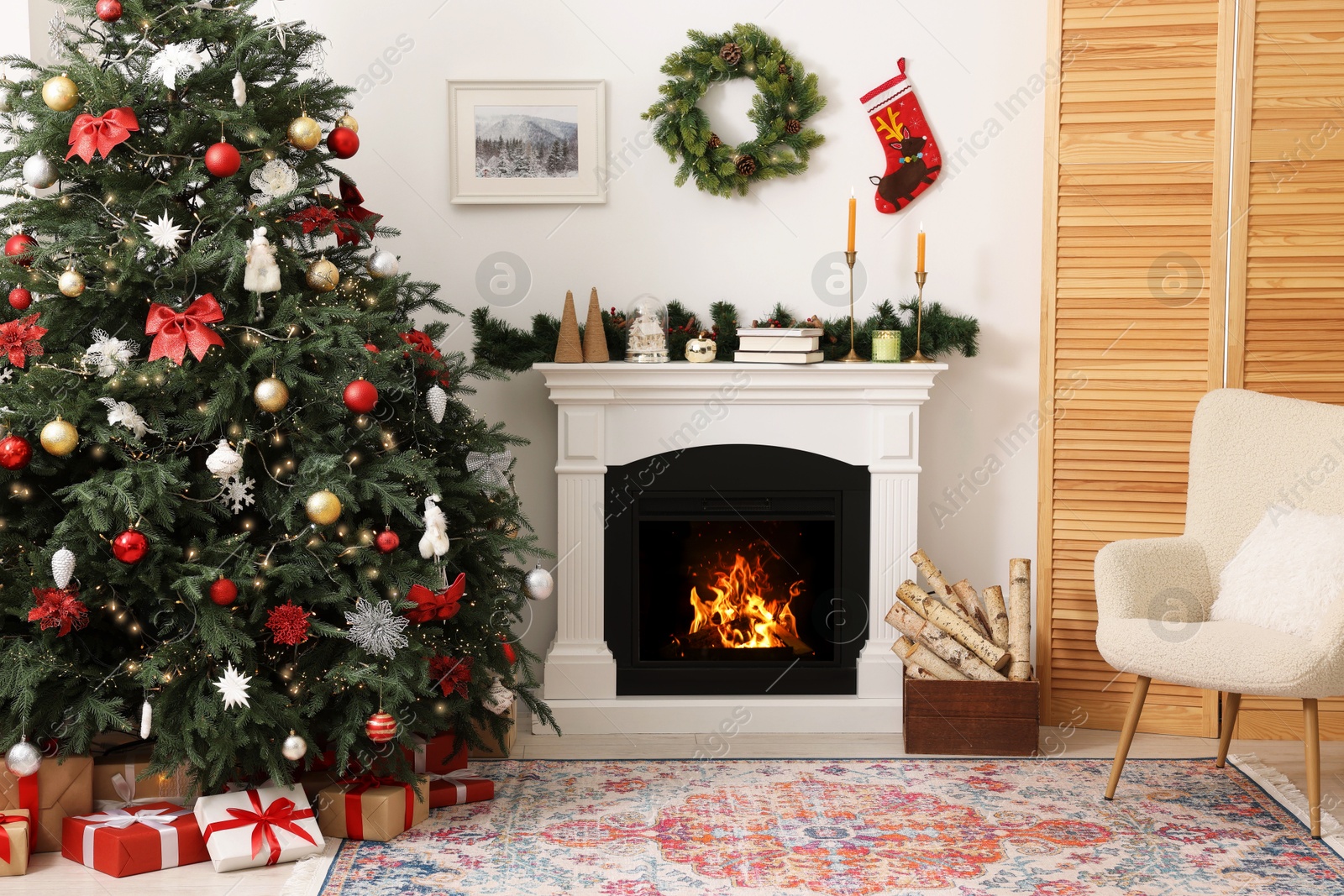 Photo of Decorated Christmas tree near fireplace in room. Festive interior design