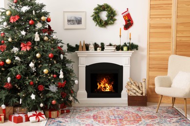 Photo of Decorated Christmas tree near fireplace in room. Festive interior design