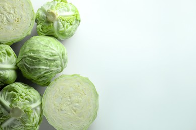 Photo of Raw green cabbages on white background, flat lay. Space for text