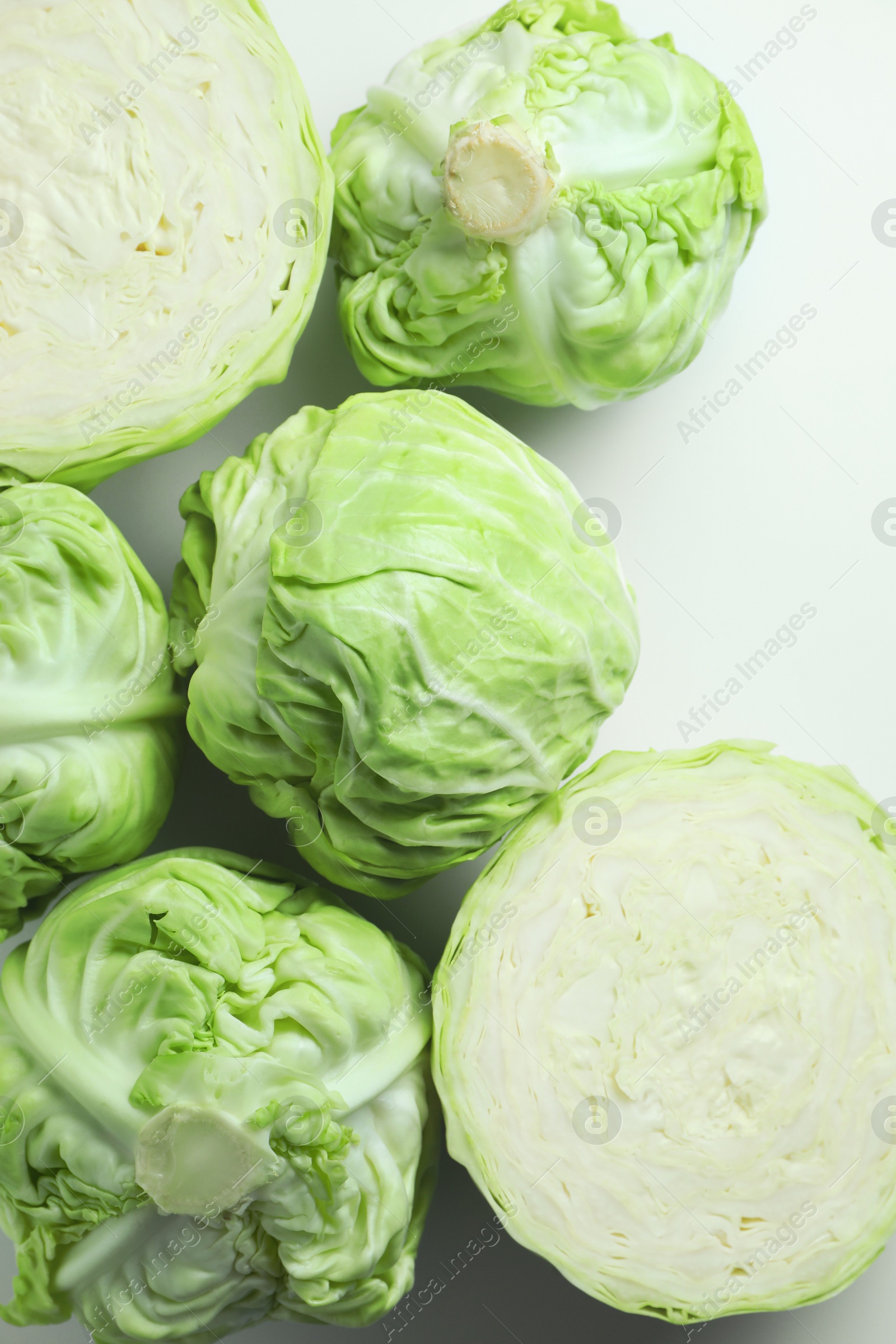 Photo of Raw green cabbages on white background, flat lay