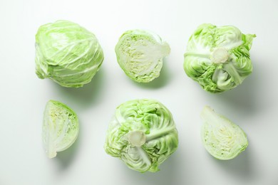 Photo of Raw green cabbages on white background, flat lay