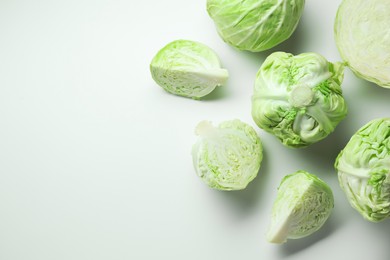 Photo of Raw green cabbages on white background, flat lay. Space for text