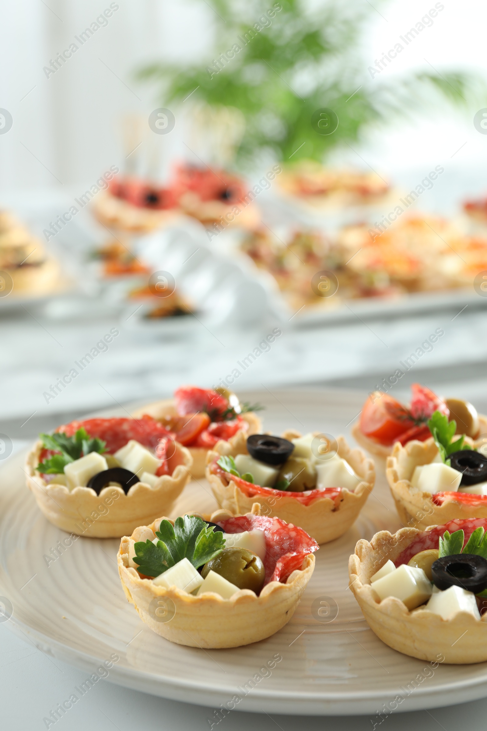 Photo of Many different tasty canapes on white table, closeup