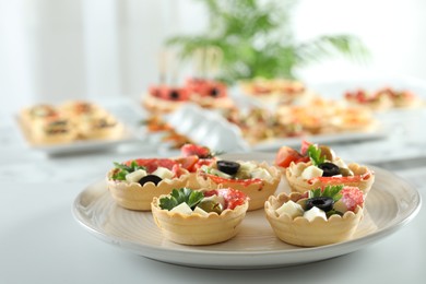 Photo of Many different tasty canapes on white table, closeup