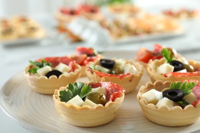 Photo of Many tasty canapes on white table, closeup