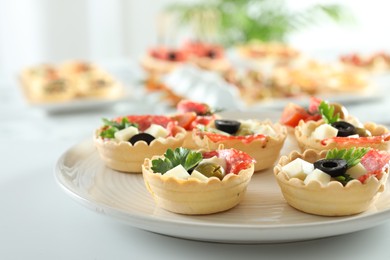 Photo of Many tasty canapes on white table, closeup