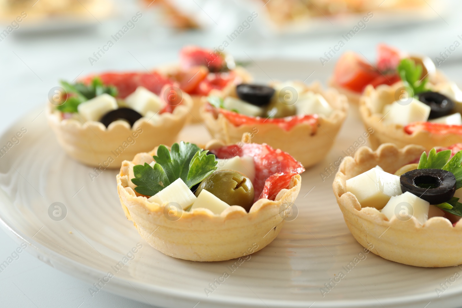 Photo of Many tasty canapes on white table, closeup