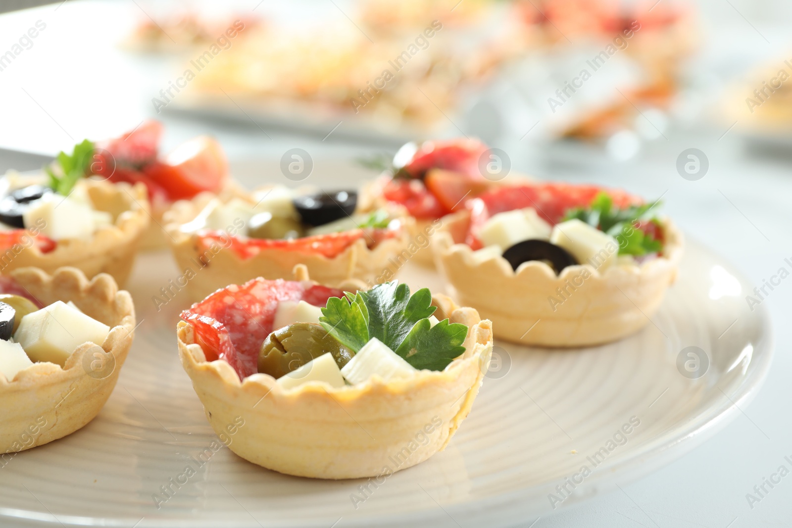 Photo of Many tasty canapes on white table, closeup