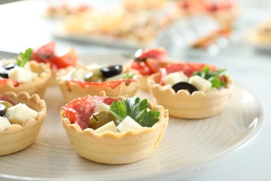 Photo of Many tasty canapes on white table, closeup