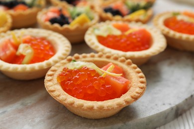 Photo of Many different tasty canapes on white wooden table, closeup