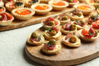 Photo of Many different tasty canapes on white table, closeup