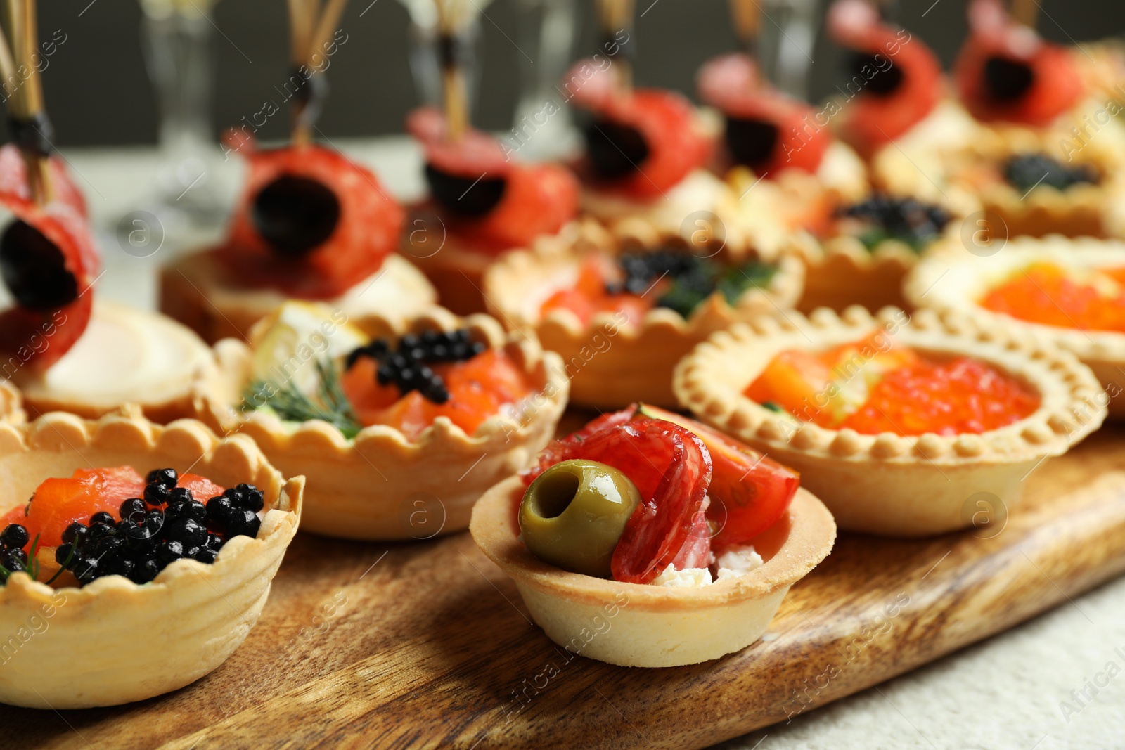 Photo of Many different tasty canapes on white table, closeup