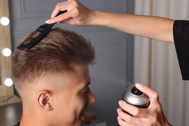 Photo of Hair cutting. Professional hairdresser working with client in barbershop, closeup