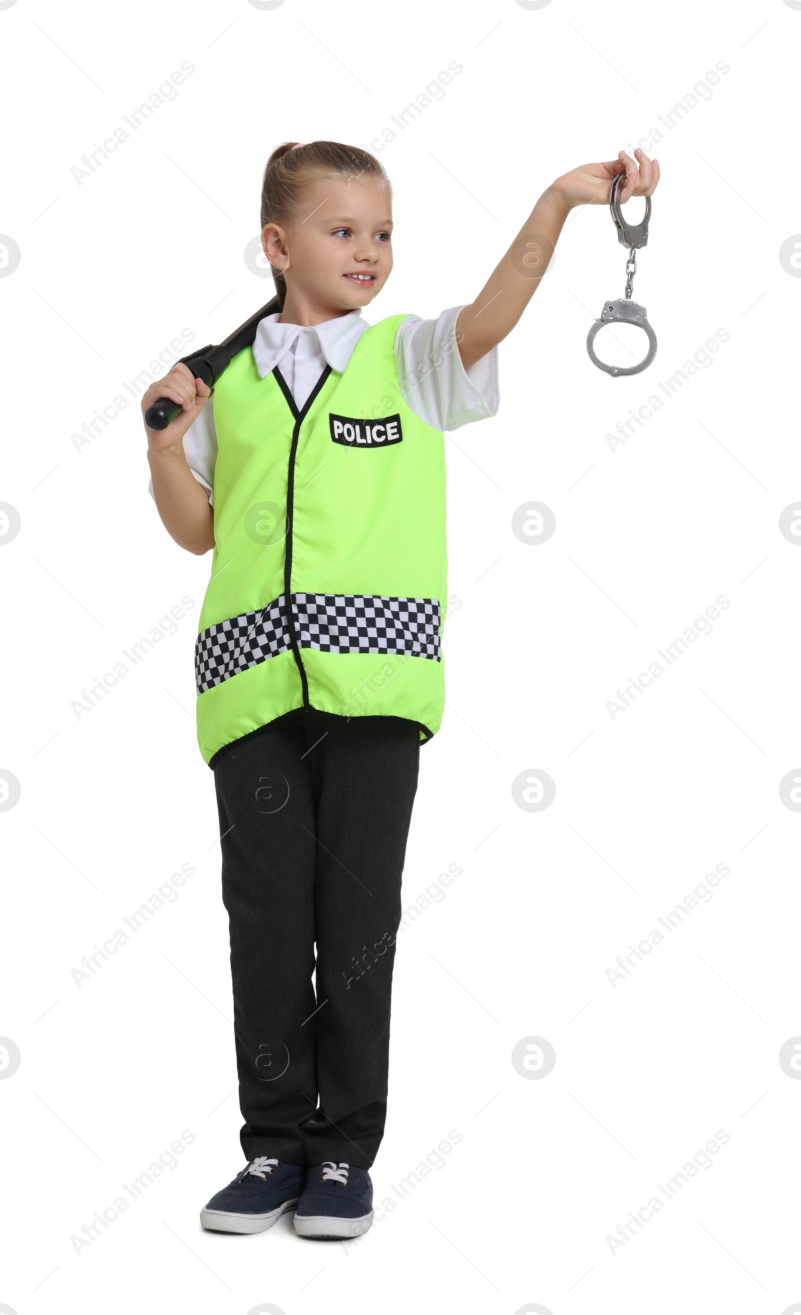 Photo of Little girl with baton and handcuffs pretending to be policewoman on white background. Dreaming of future profession