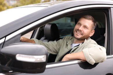 Photo of Man driving modern car, view through window