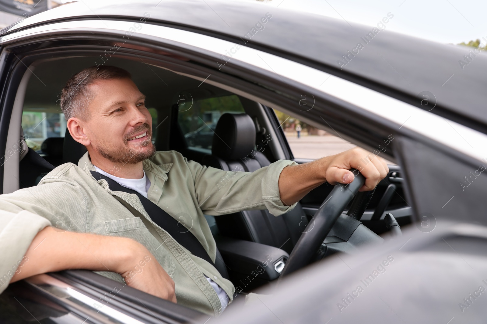 Photo of Man driving modern car, view through window