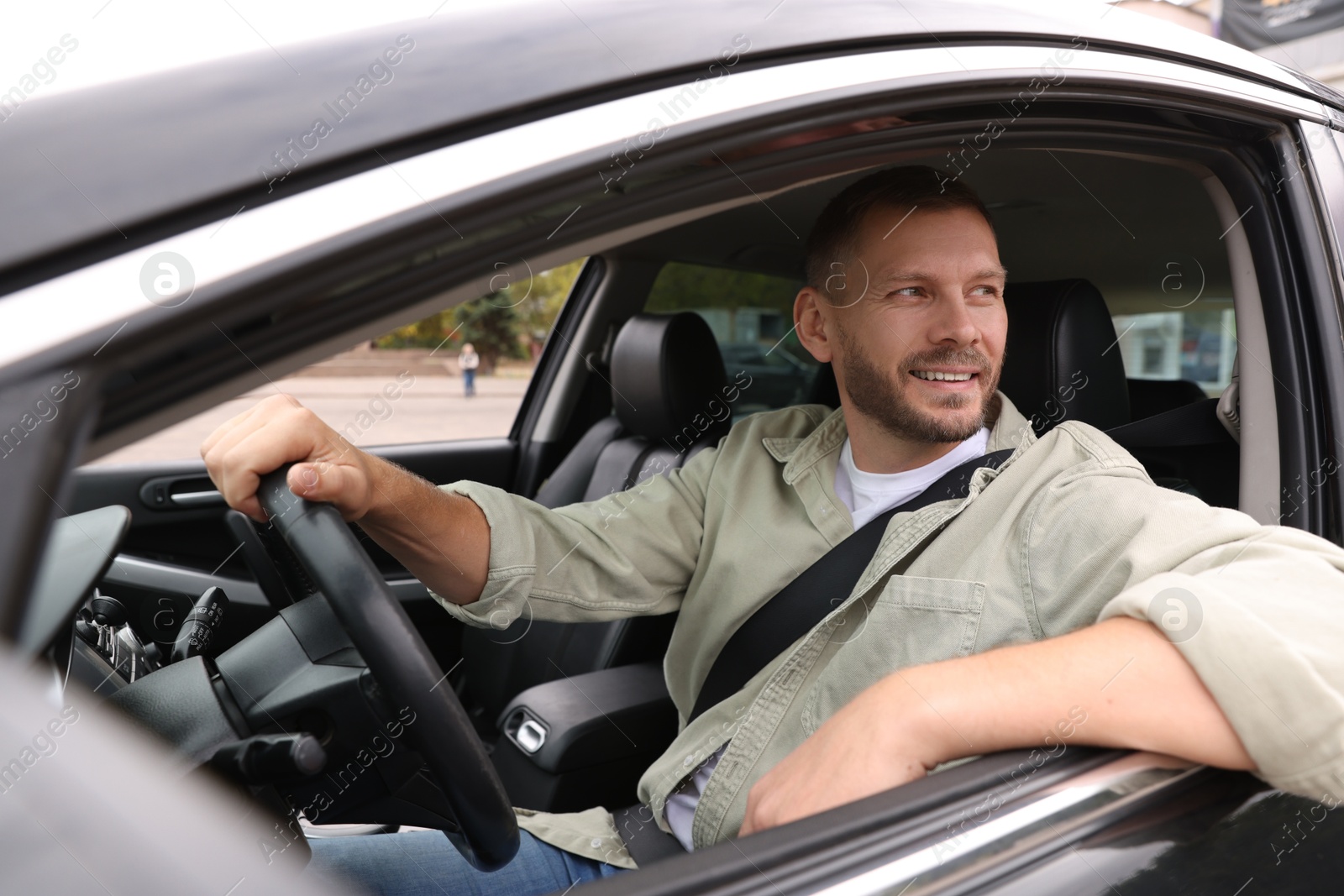 Photo of Man driving modern car, view through window