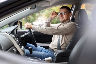 Photo of Man driving modern car, view through window