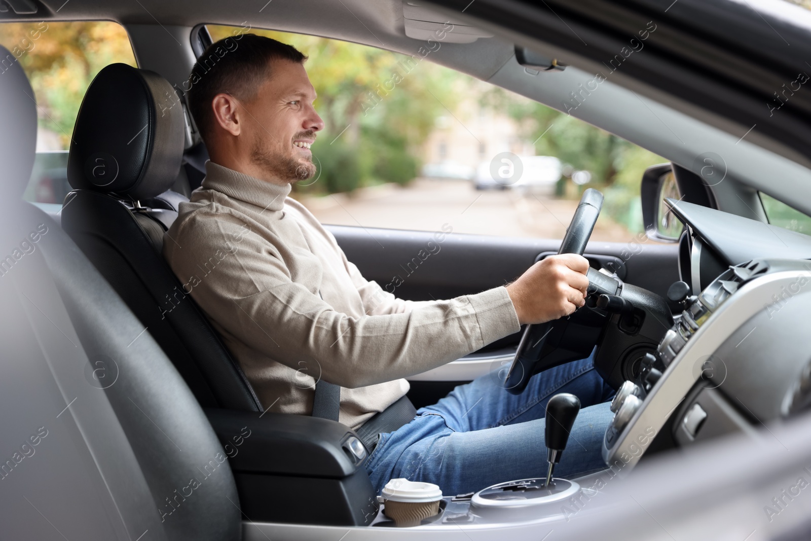 Photo of Man driving modern car, view through window