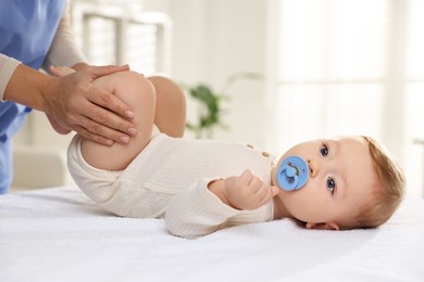 Photo of Pediatrician with little child in clinic, closeup. Checking baby's health